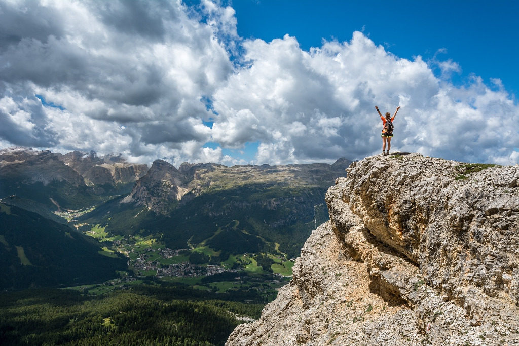 Somewhere exciting: on top of a mountain overlooking a valley below