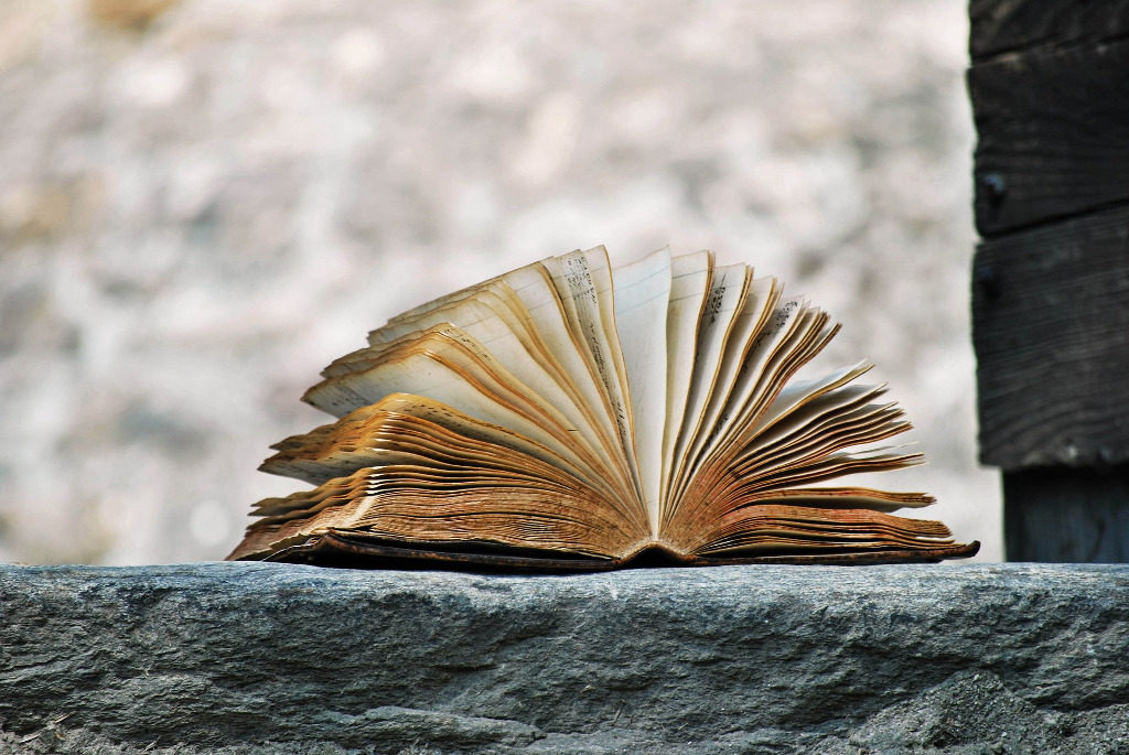 Open book on a wall outside